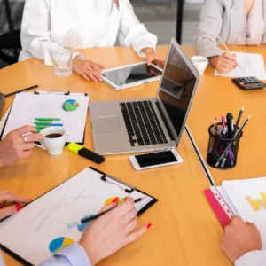A group of people sitting around a table discussing a project.