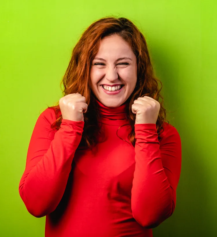 Happy woman smiling against green background